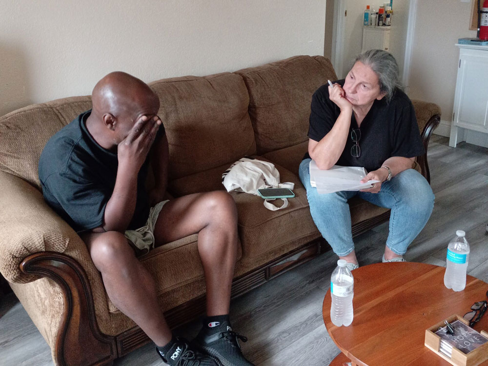 A man and a woman sitting on a couch talking