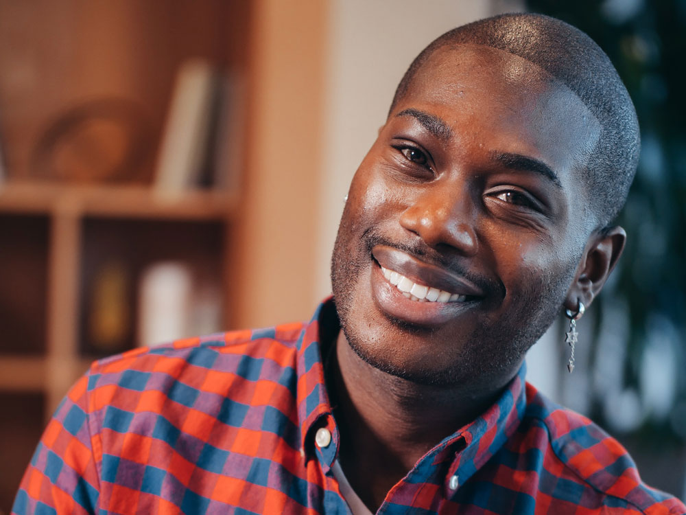 Young man smiling into the camera with confidence 