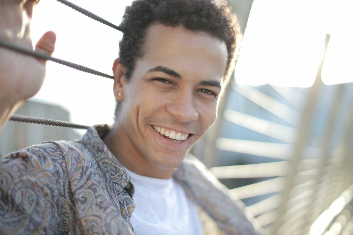 young man looking at camera with a confident smile on his face